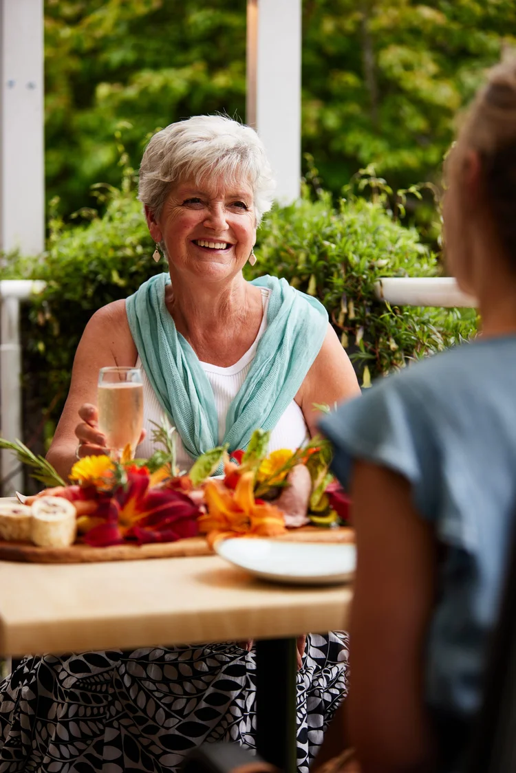 An elderly woman enjoying fine dining at the Royal Botanical Gardens in Tasmania, Australia.