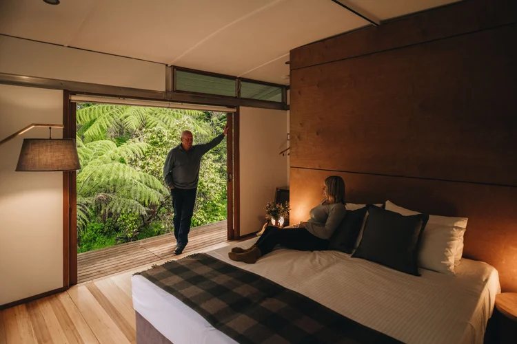 Two elderly hikers enjoy a moment of cozy relaxation in their room at The Twelve Apostles Lodge in Johanna on the Great Ocean Road.