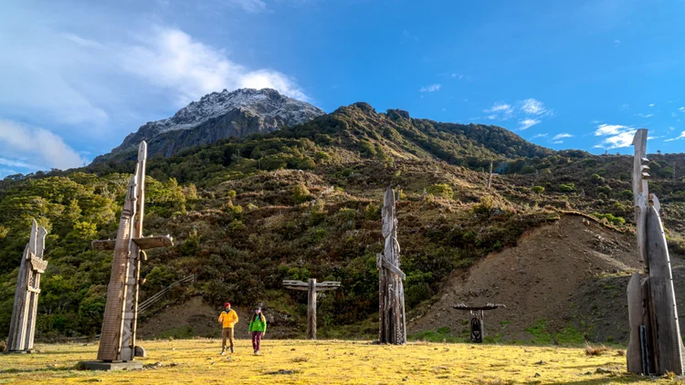 A couple hiking on Mount Hikurangi and visiting a cultural site in Gisborne on the North Island of New Zealand.