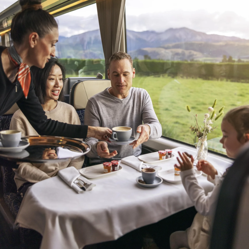 A family taking the Tranz Alpine scenic train from Christchurch to Greymouth, Canterbury, New Zealand.