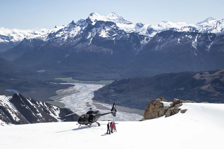  Private helicopter in the majestic Southern Alps of New Zealand, offering passengers access to snow-capped peaks and thrilling mountain trails.